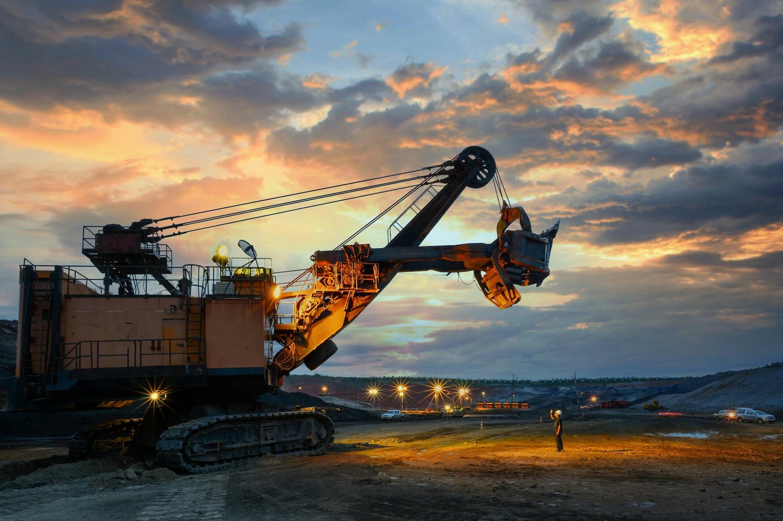 yellow and black heavy equipment at the site during sunset